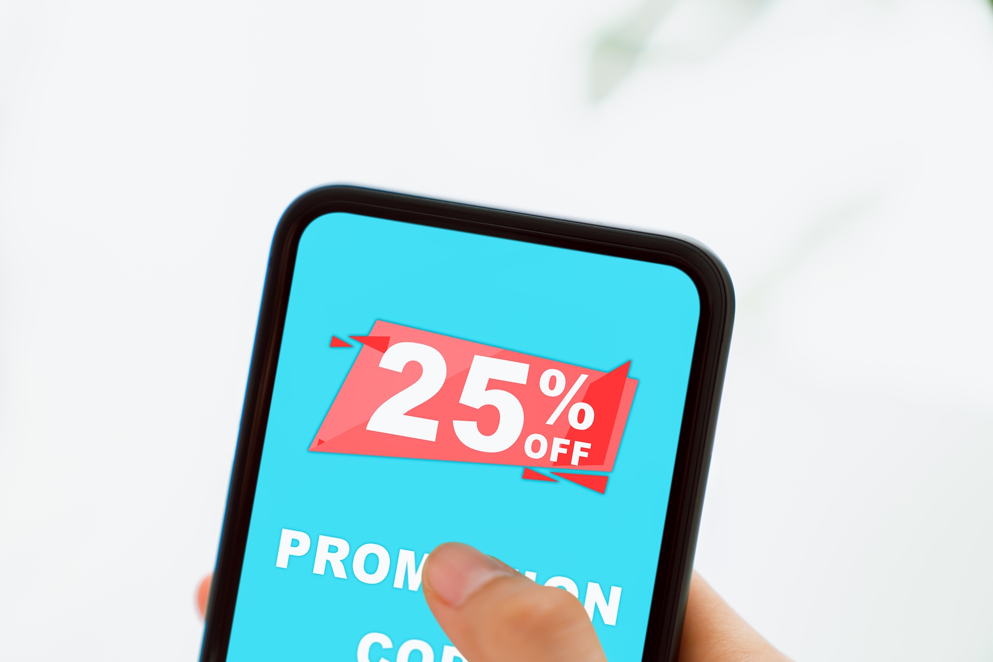 Woman holding smartphone to enter the code to get a discount from the store.